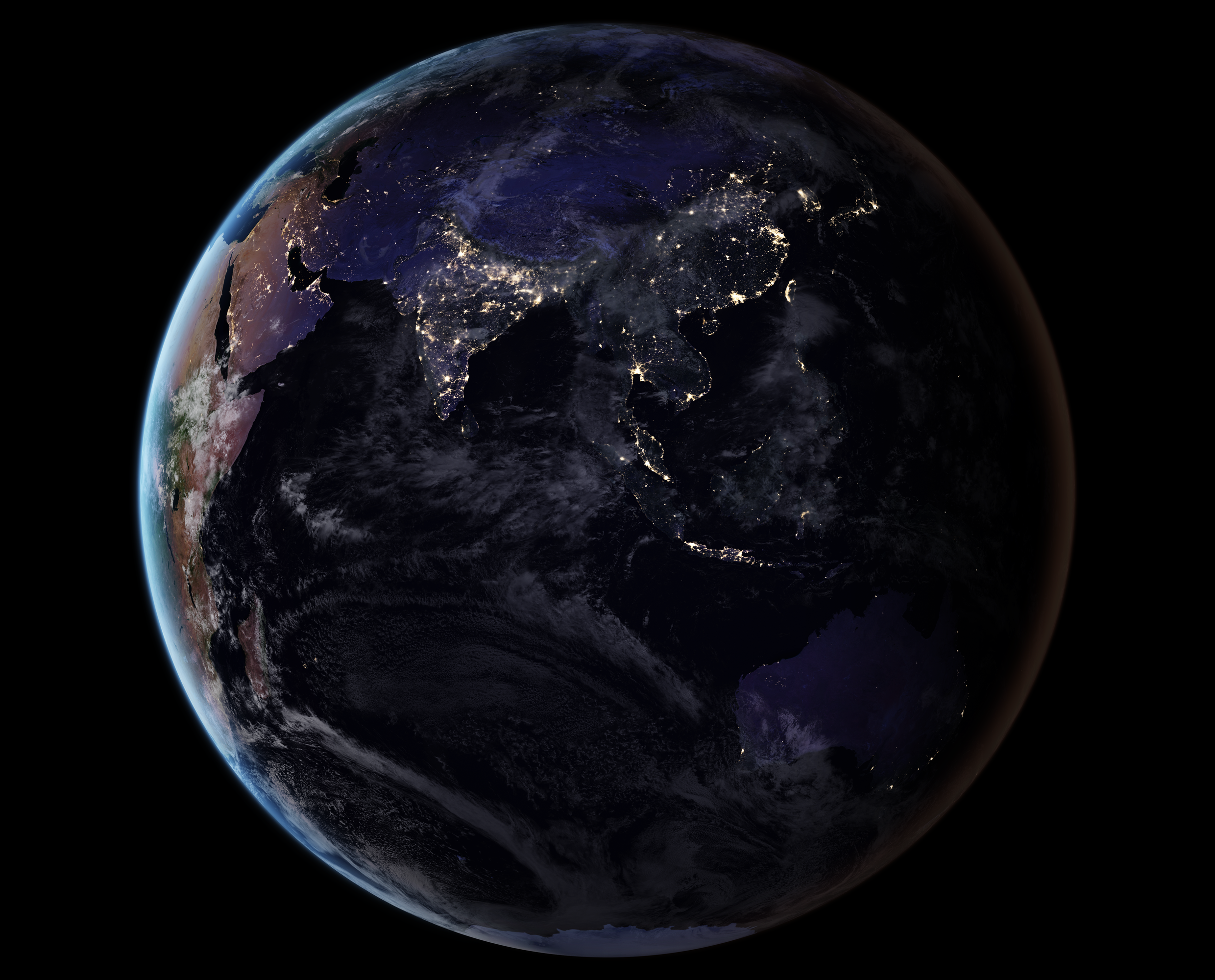 Asia at night, with illuminated cities and a blue atmospheric edge, viewed from space