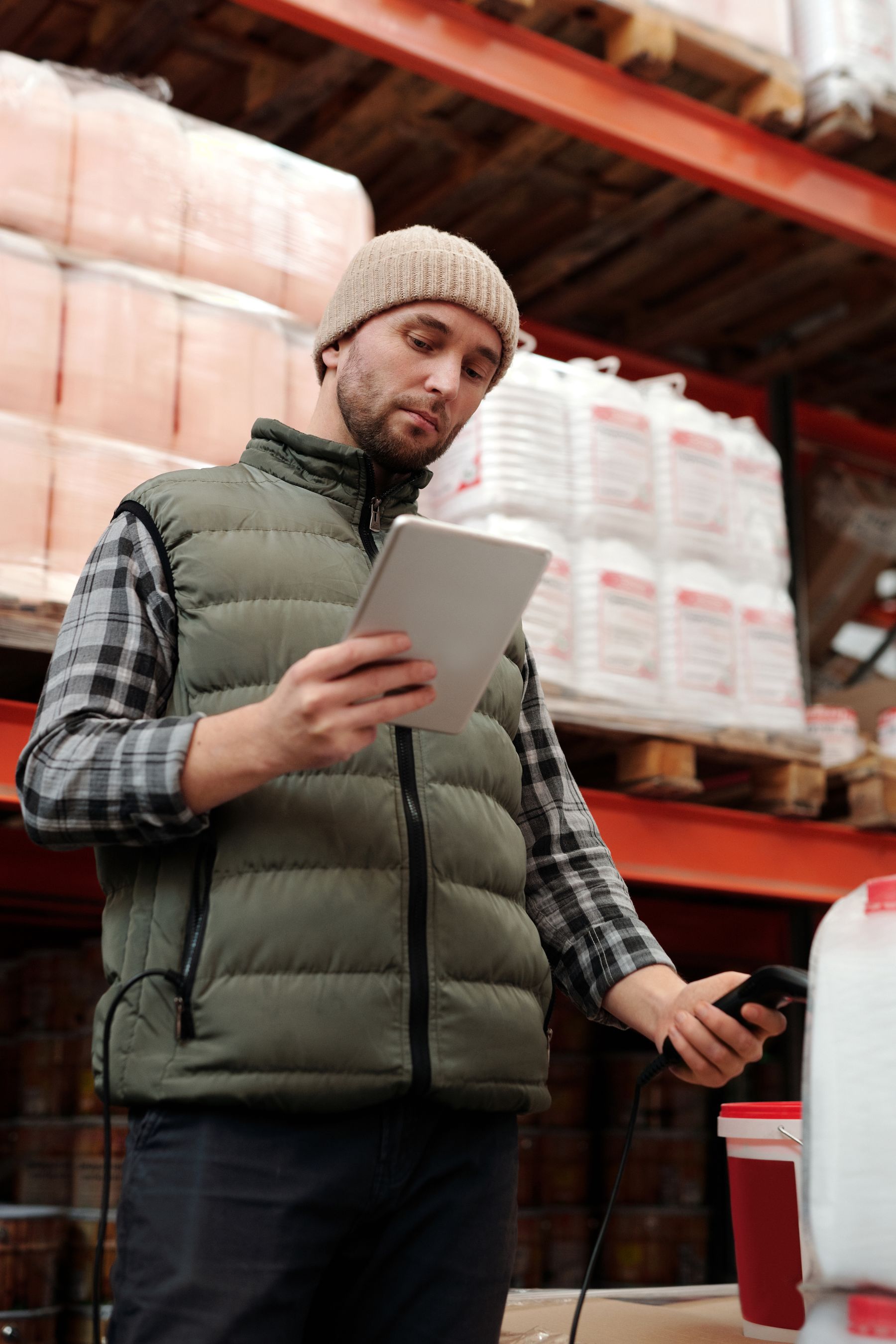 Warehouse operator checking product inventory with a tablet